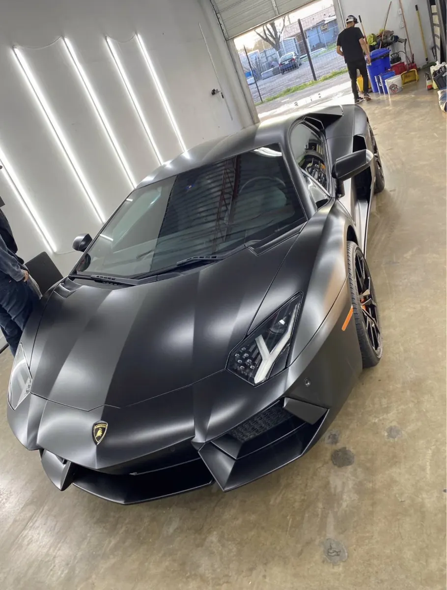Matte black Lamborghini inside the workshop